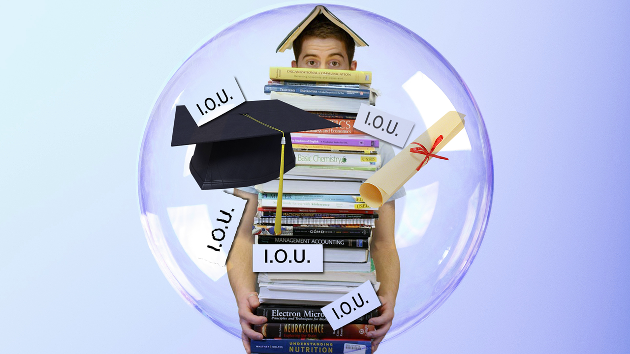 a male student holding a stack of textbooks with "IOU" and graduation cap