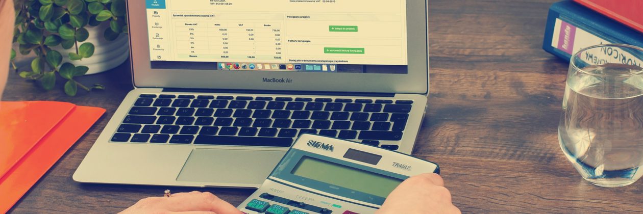 women working calculator and laptop at desk