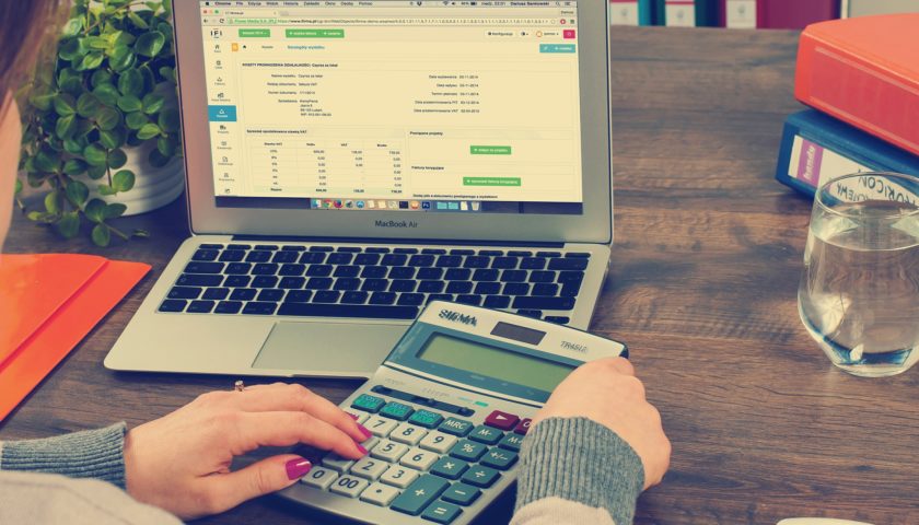 women working calculator and laptop at desk