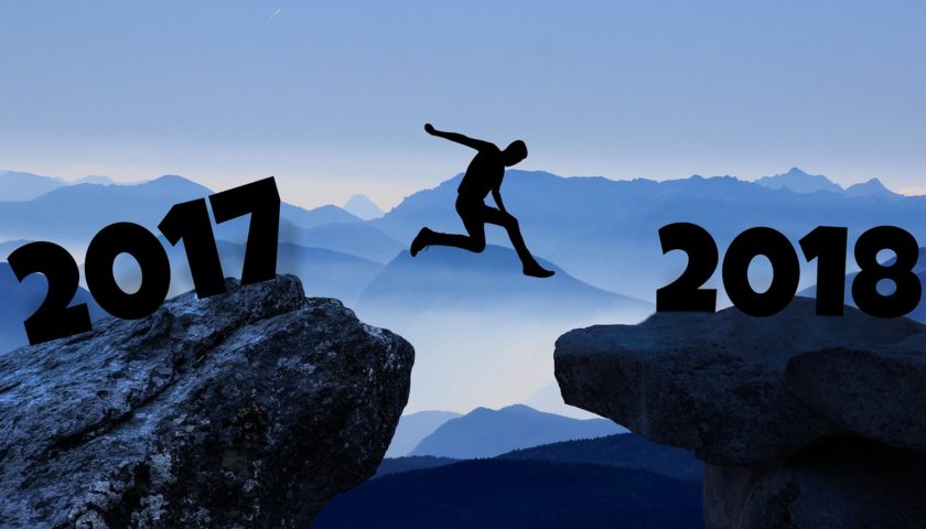 person jumping over a cliff with "2017" on left and "2018" on the right