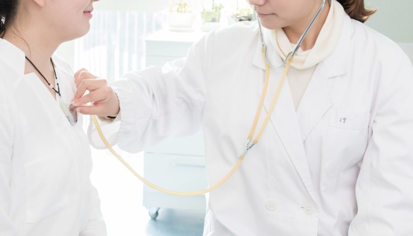 provider listening to patients heart with stethoscope