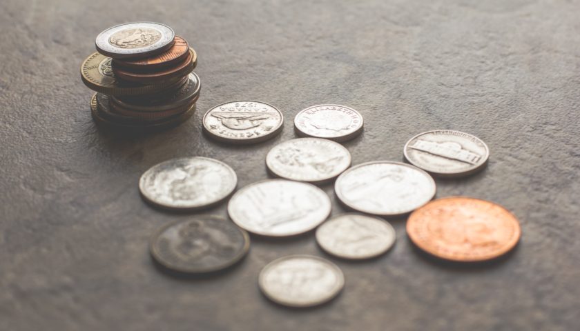 various coins on a grey surface