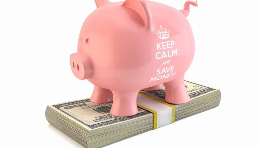 pink piggy bank on stack of money "keep calm and save money"