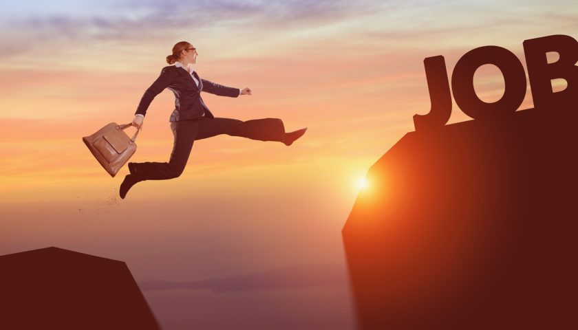person in a suit jumping over a canyon with sun in background to "job"
