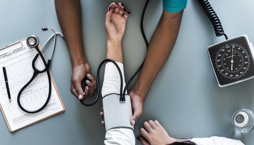 person taking a blood pressure with blood pressure cuff