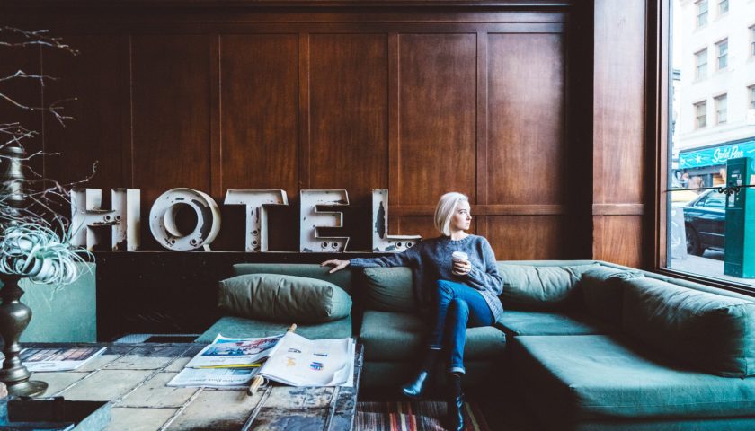 lady sitting on couch in a hotel lobby