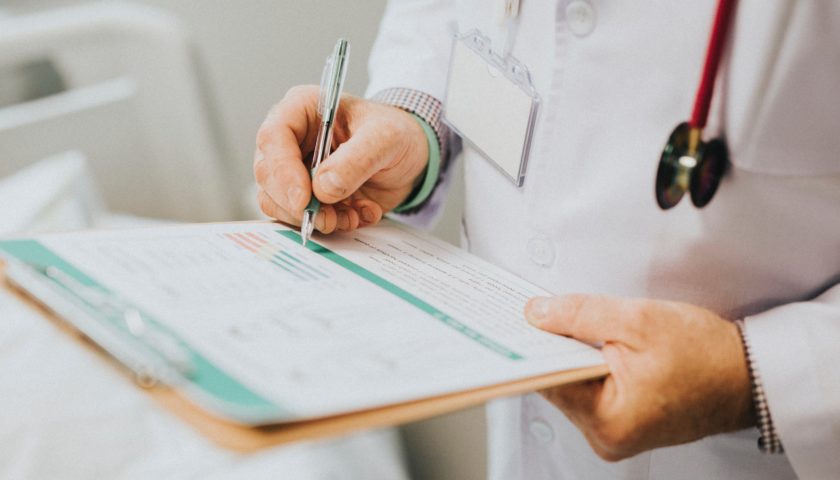 medical professional holding a clip board