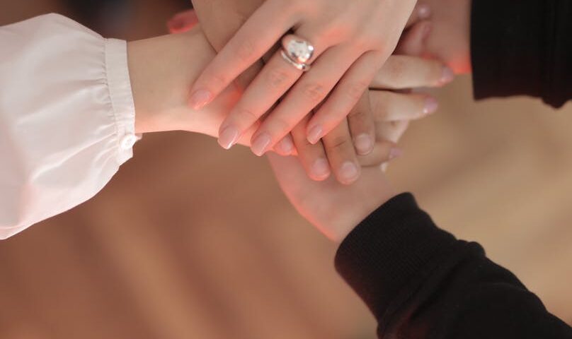 crop friends stacking hands together