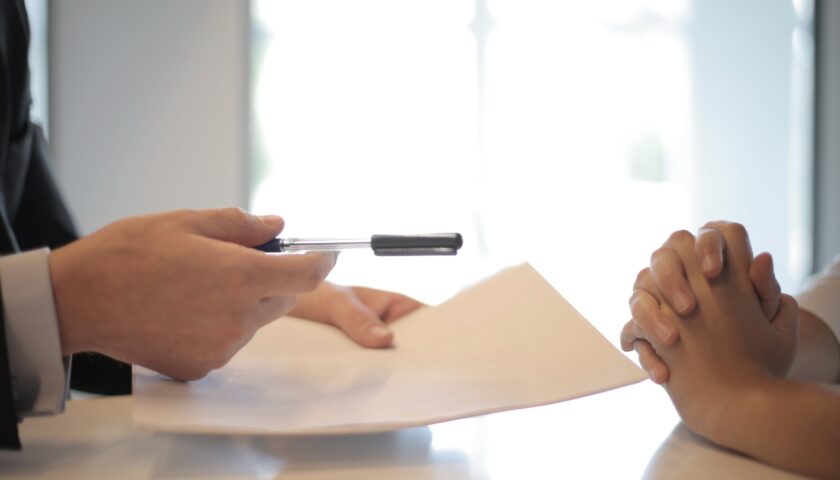 crop businessman giving contract to woman to sign