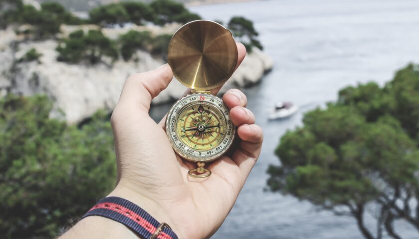 person holding compass