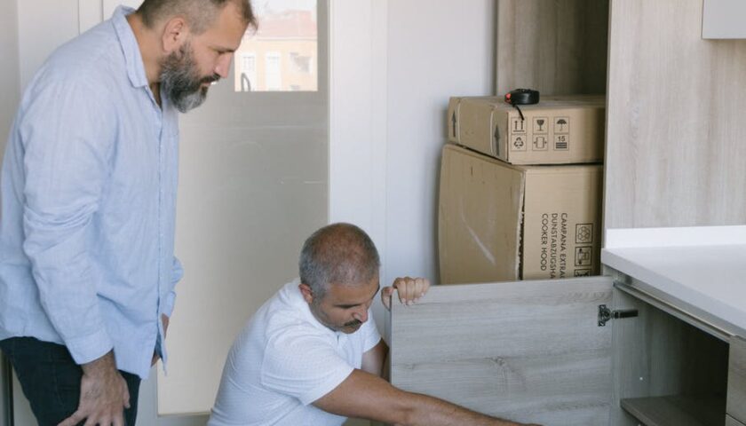 a man pointing inside a cabinet